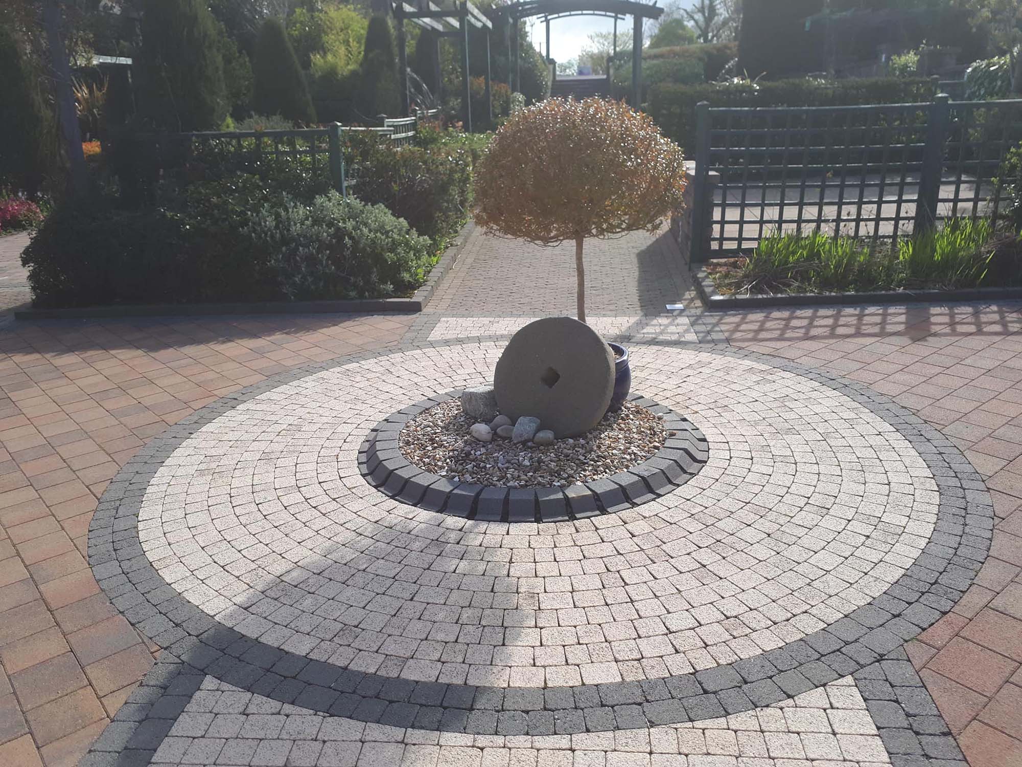 Circular paving design with a tree in the middle